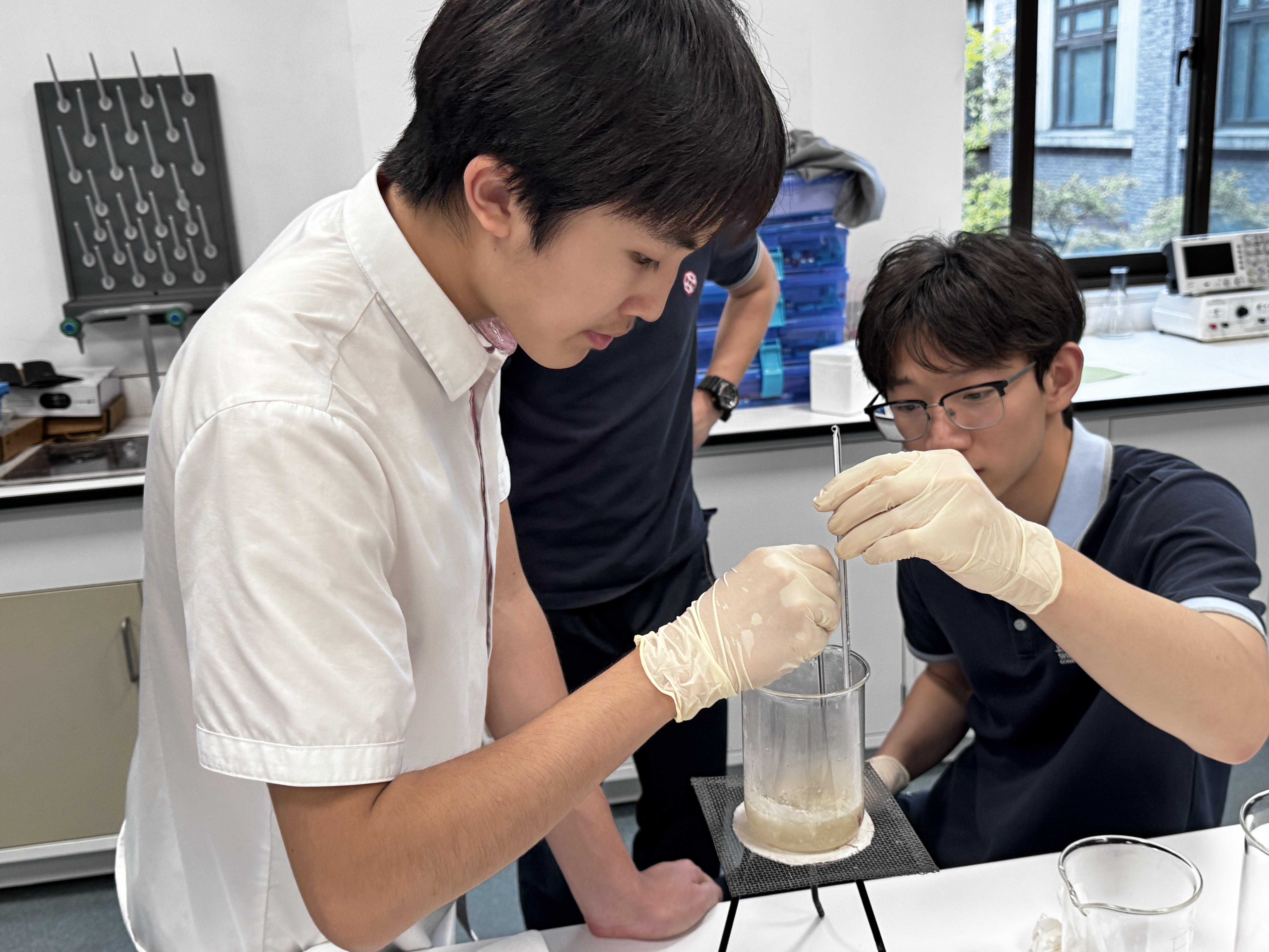 Student preparing dye filtration setup with stirrer