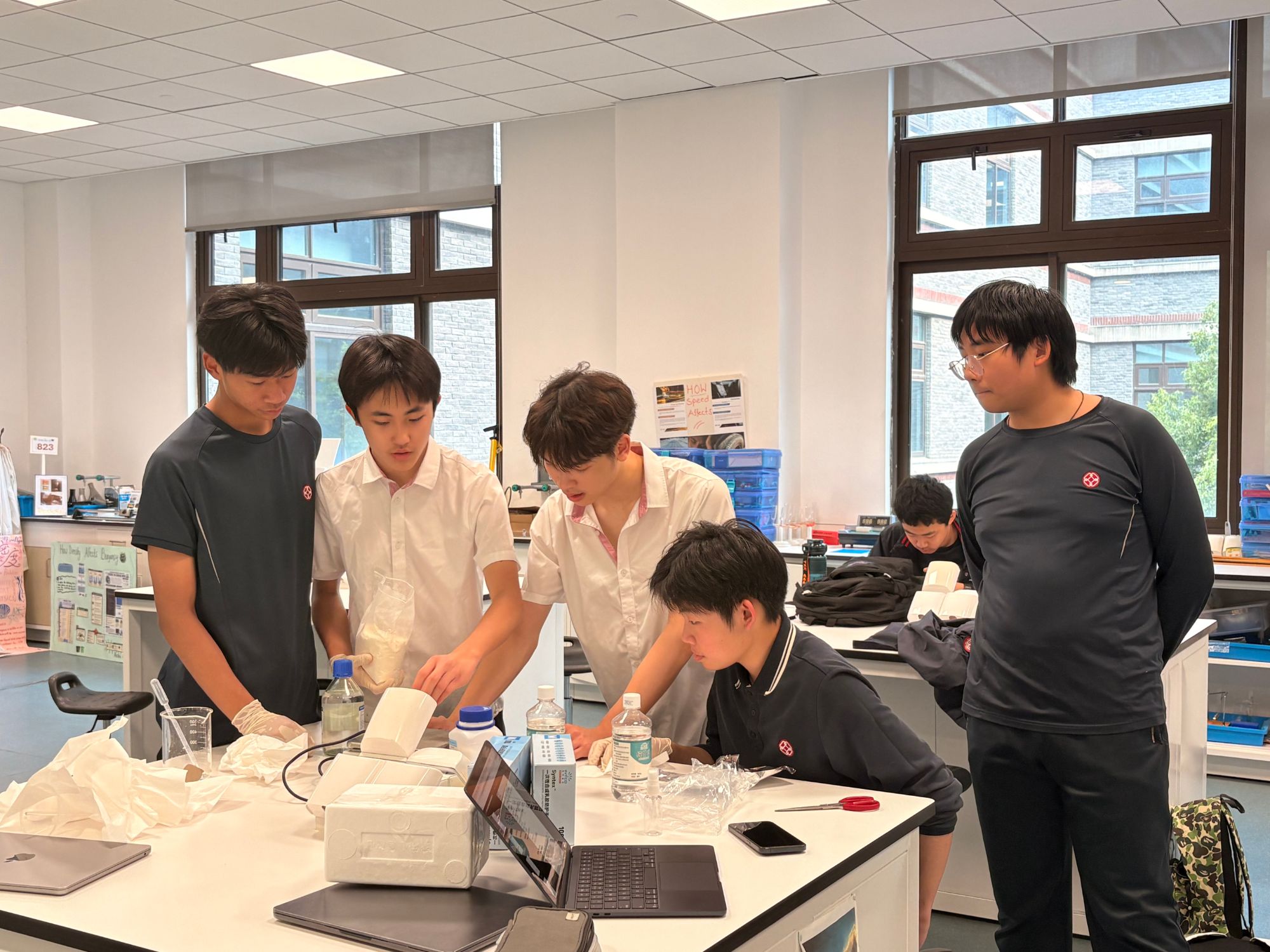 Team configuring compressive load-test setup for lattice bridge specimens